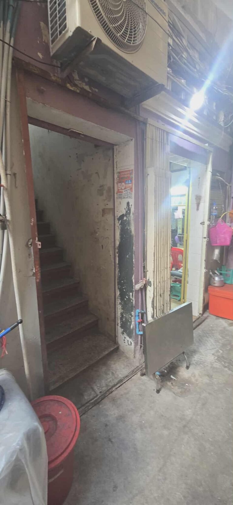 Ground-floor entrance and stairwell of a traditional Phnom Penh shophouse building