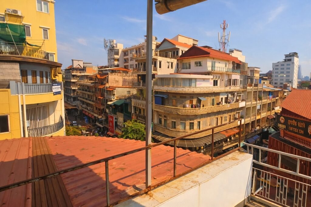 View over central Phnom Penh streets and rooftops from a private top-floor apartment balcony